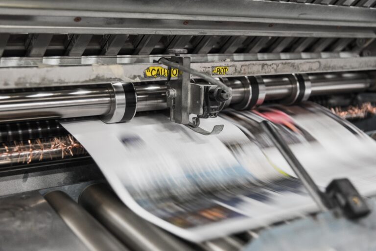 Newspaper press with newspapers being printed