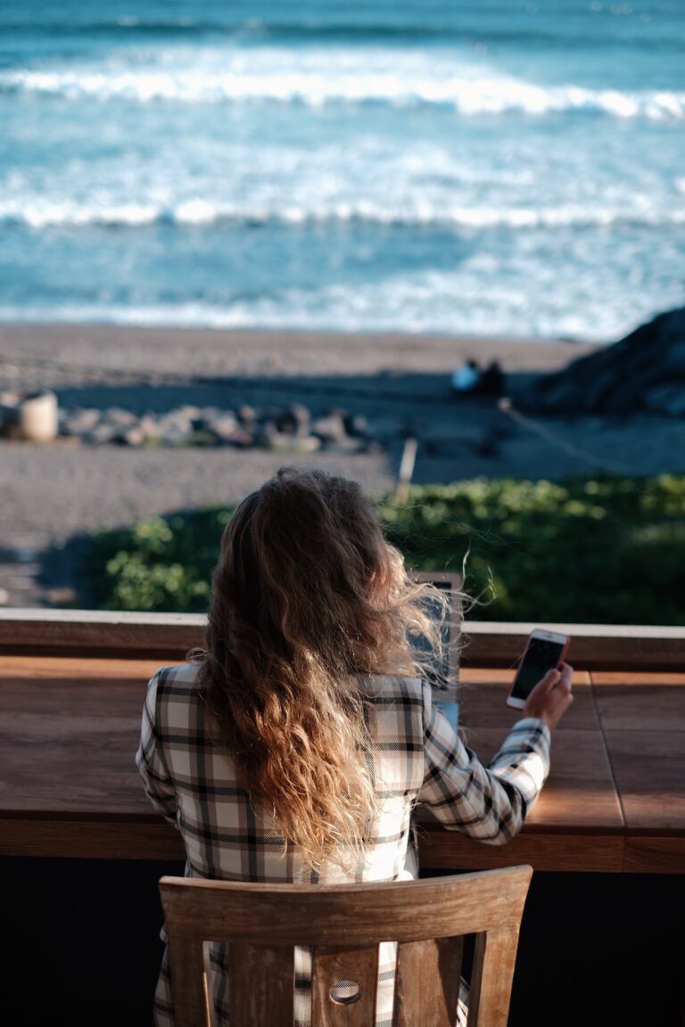 woman siting at a table working at the beach