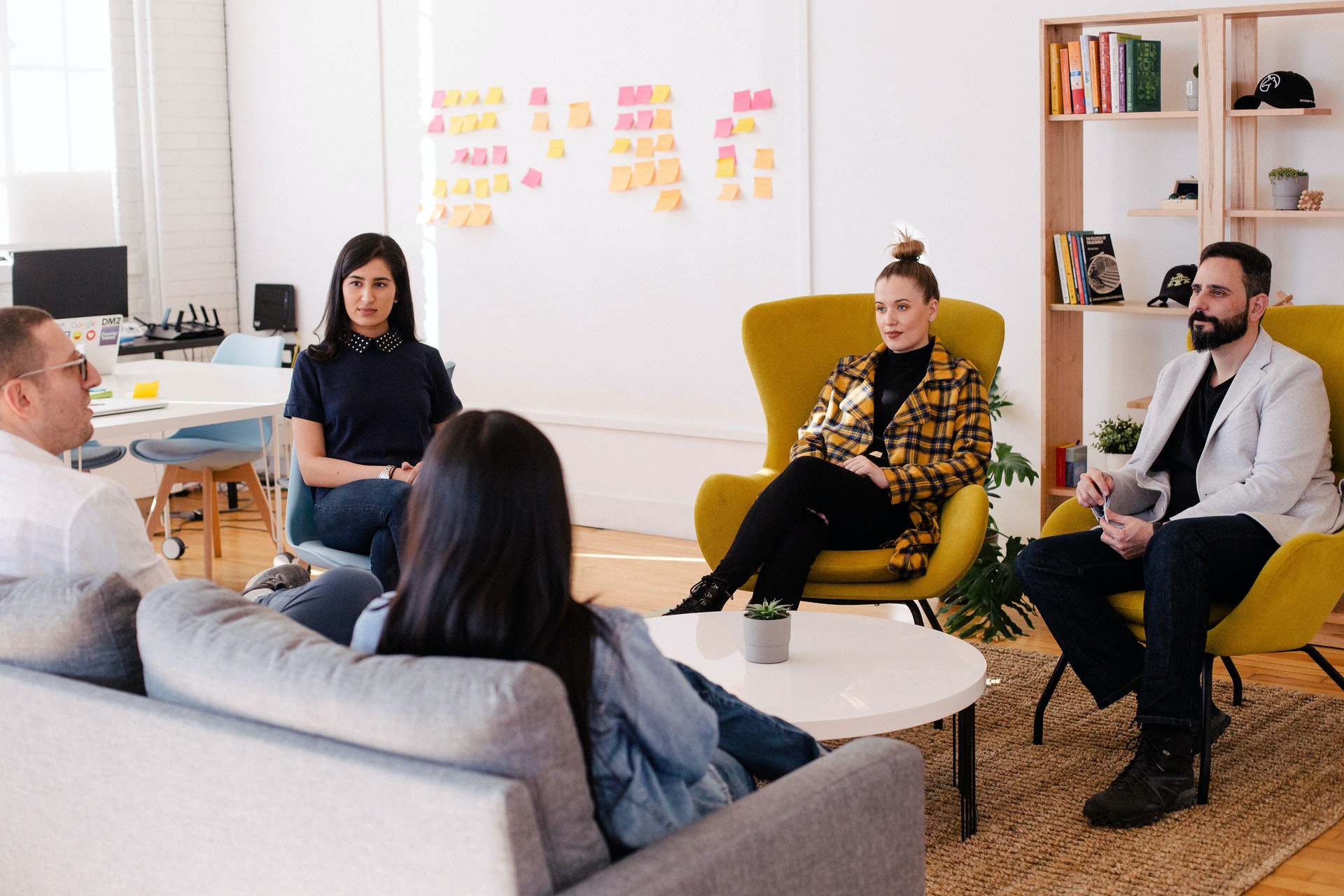 focus group of people sat in a circle in a room for market research