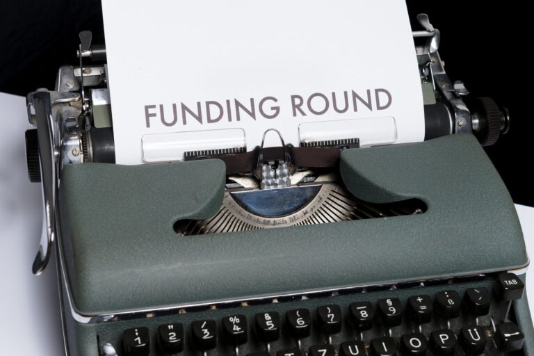 piece of paper in a typewriter with the words Funding Round typed on it