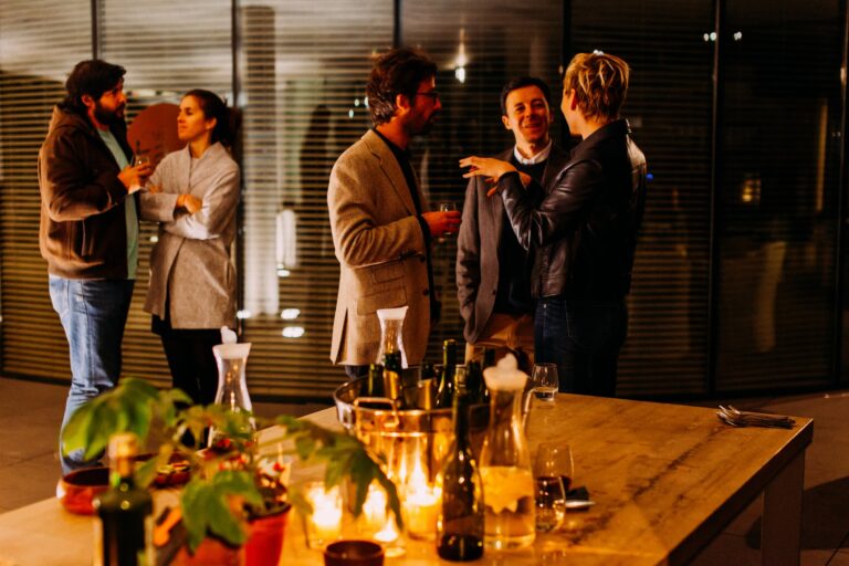 networking event with business men and women drinking and talking