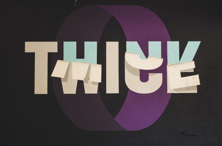 A black background with a purple tube overlayed with the word Think.