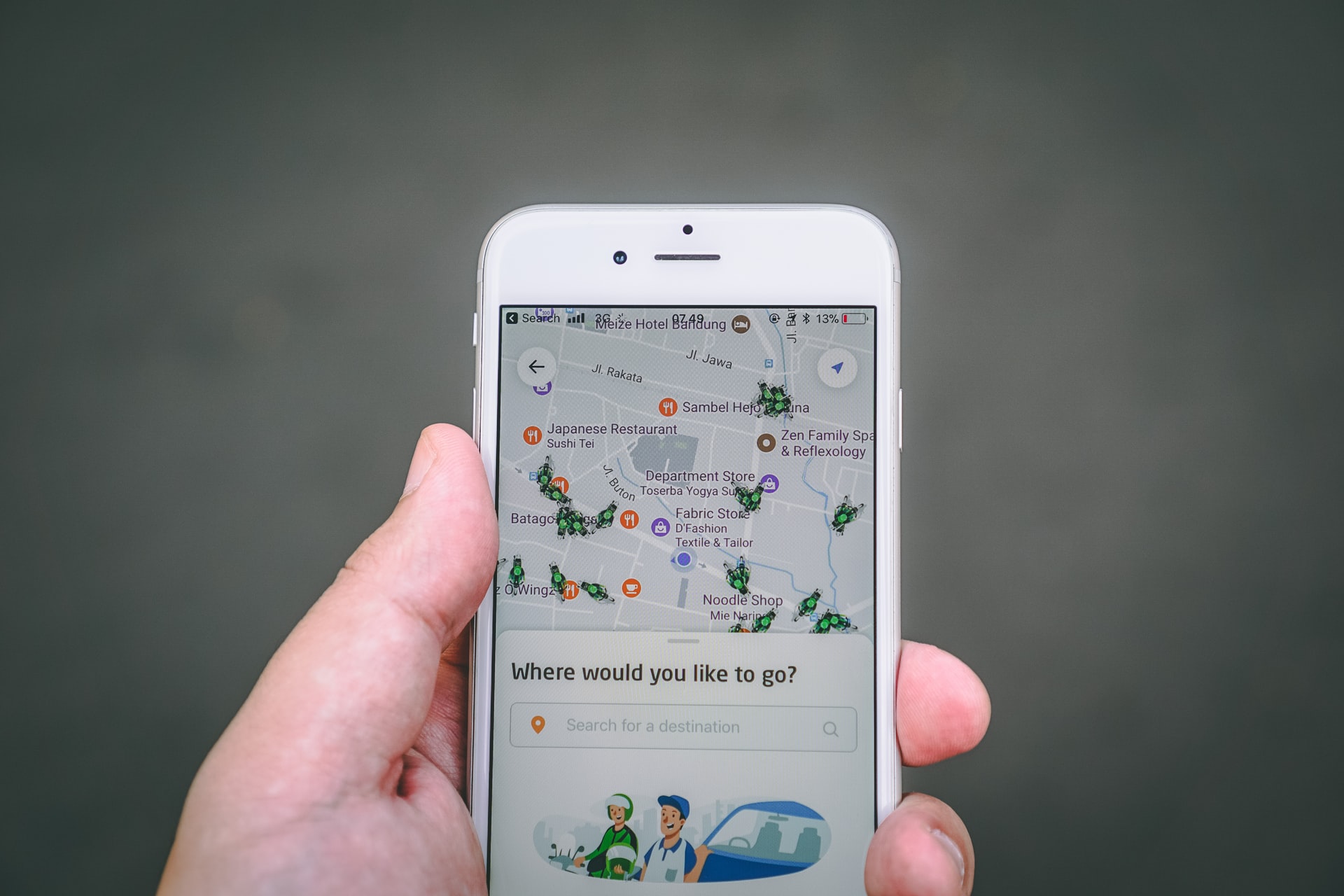 Man holding a smart phone for taxi company