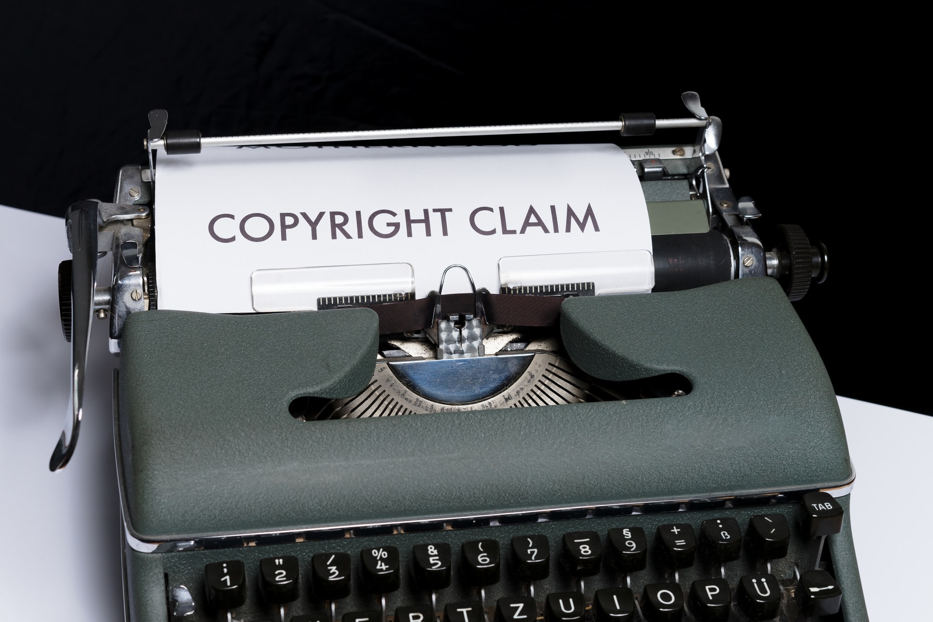 Typewriter with a sheet of typed paper which reads copyright claim