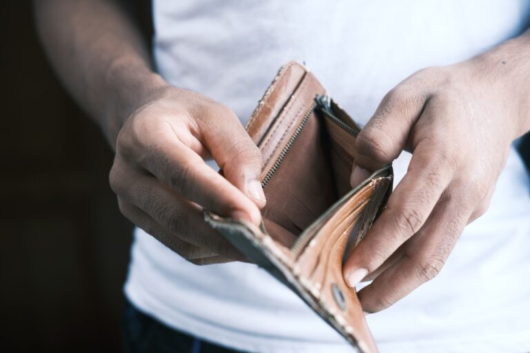 man holding his empty wallet open. Business in a recession
