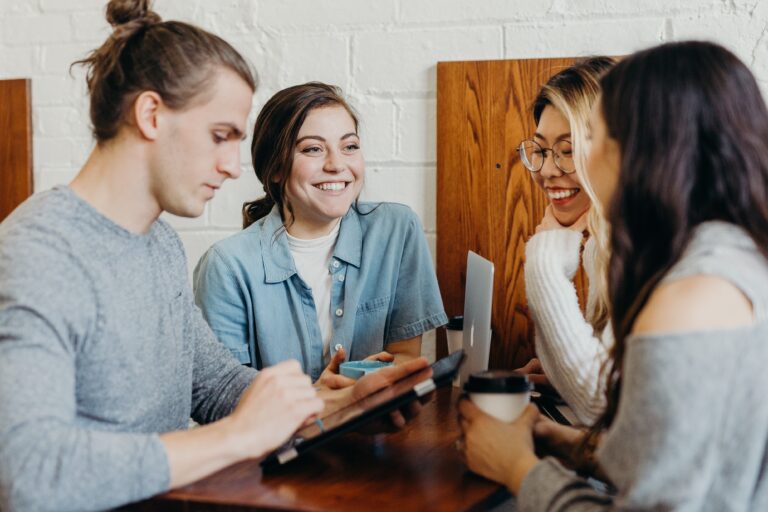 Four male and female employees working proactively together