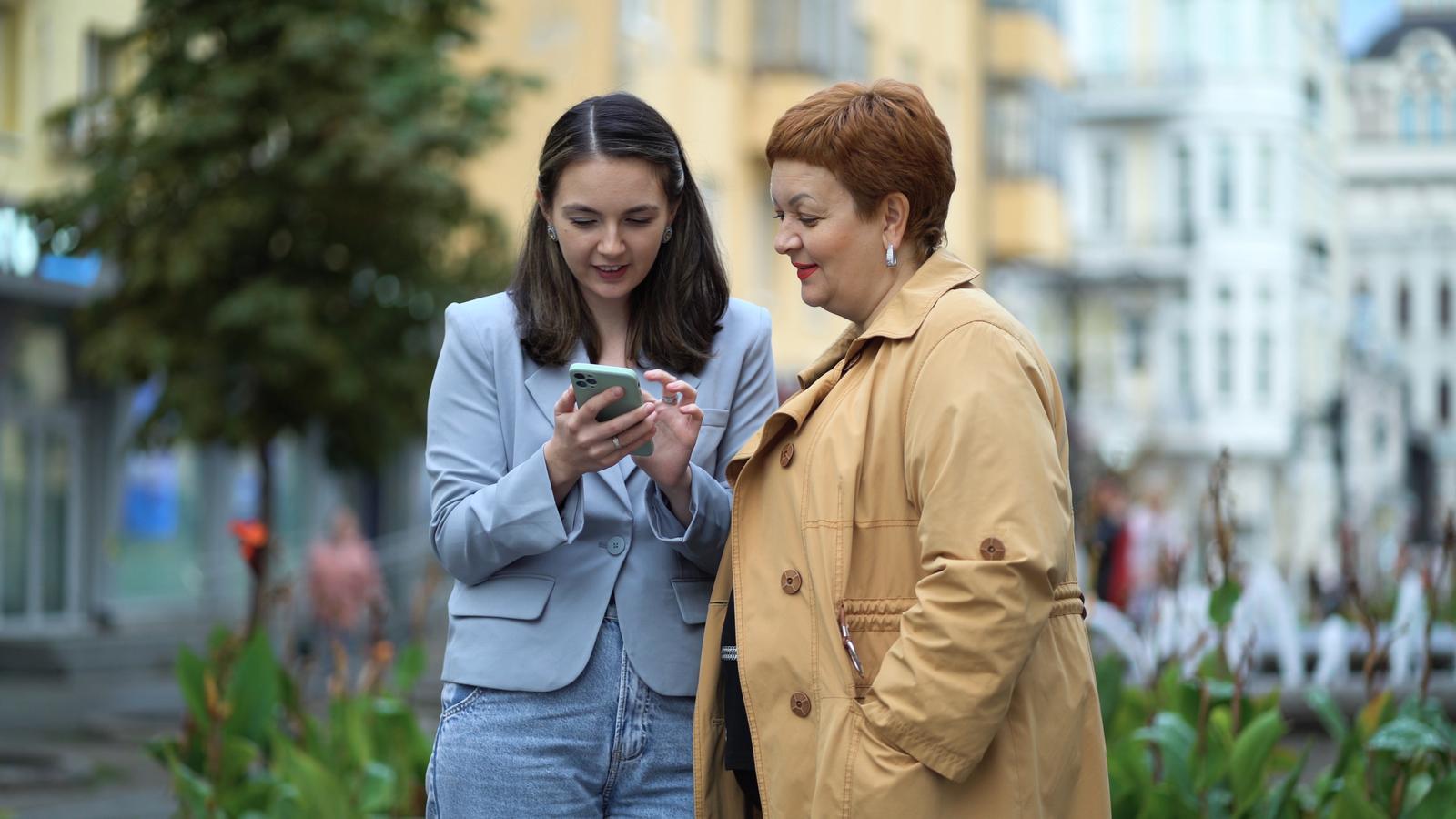Two professional women connecting with others via social media