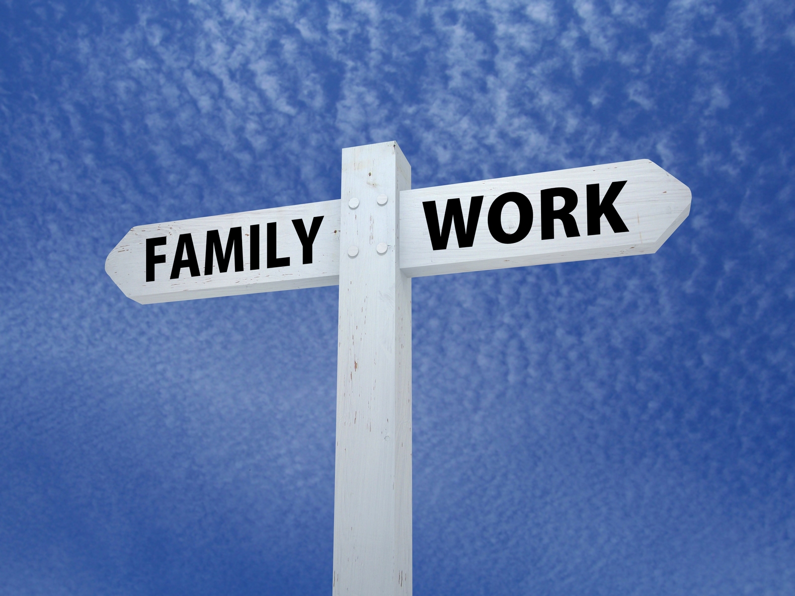 a white sign post with two arrows on a blue background. One arrow says Family the other arrow says Work