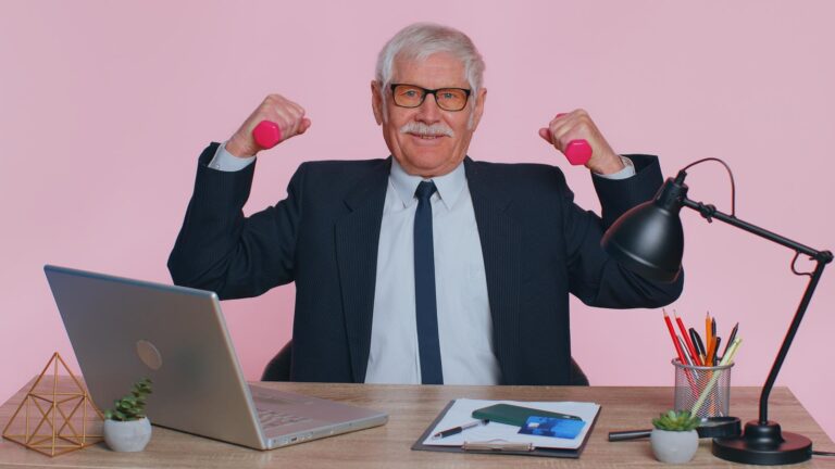 mature business man using exercise equipment to keep fit at work.