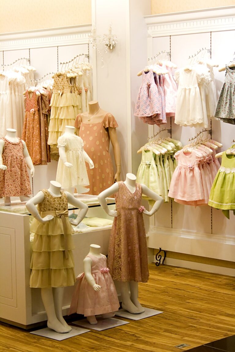 Pop up shop for childrens clothing with numerous dresses displaed on dummies and hangers