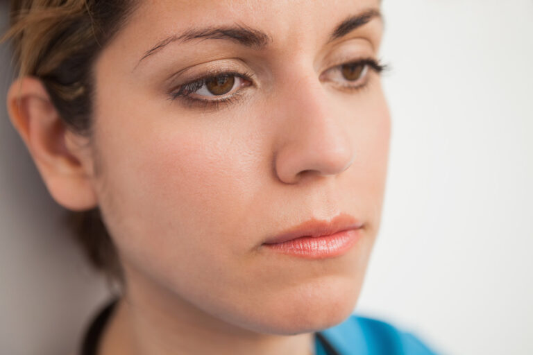 Young woman looking disappointed after receiving a job rejection
