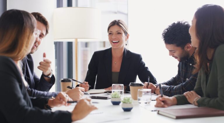 Business people around a table displaying agile entrepreneurship by discussing ideas and industry relevant news