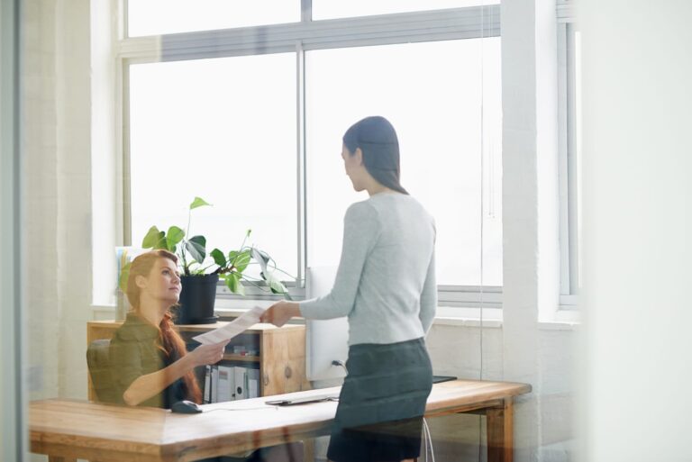 A woman handing her notice in to her female boss.