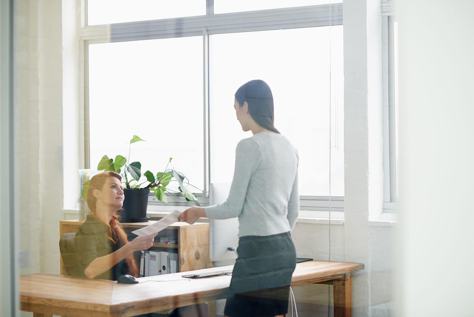 A woman handing her notice in to her female boss.