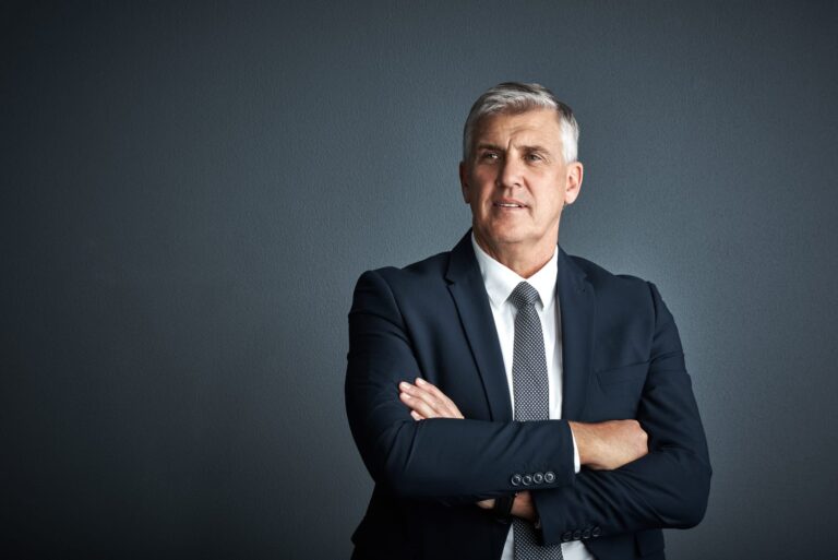Mature business man in suit experiencing decision fatigue.