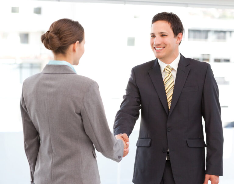 A business man and a business woman shaking hands