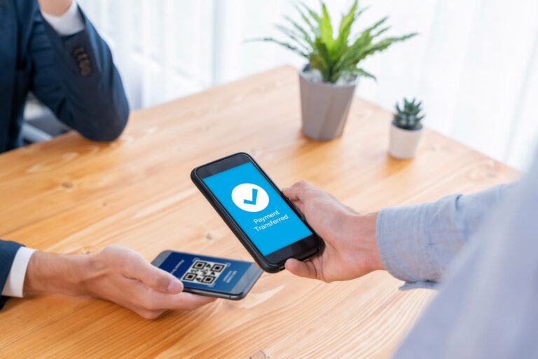 A customer making a payment with his smartphone using a QR Code.