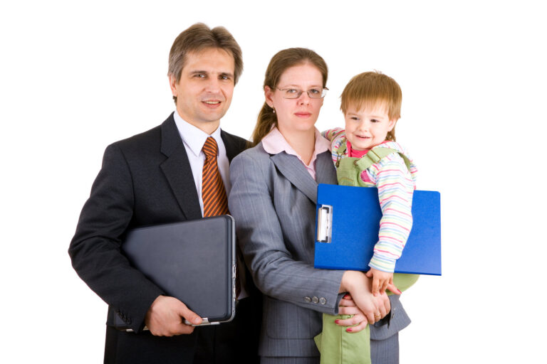 Parents holding their young child. They are dressed formally for business and the child is holding a clipboard to indicate a family business.